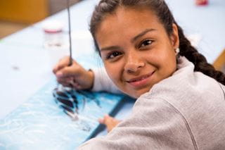 Student creating an illustration of a turtle