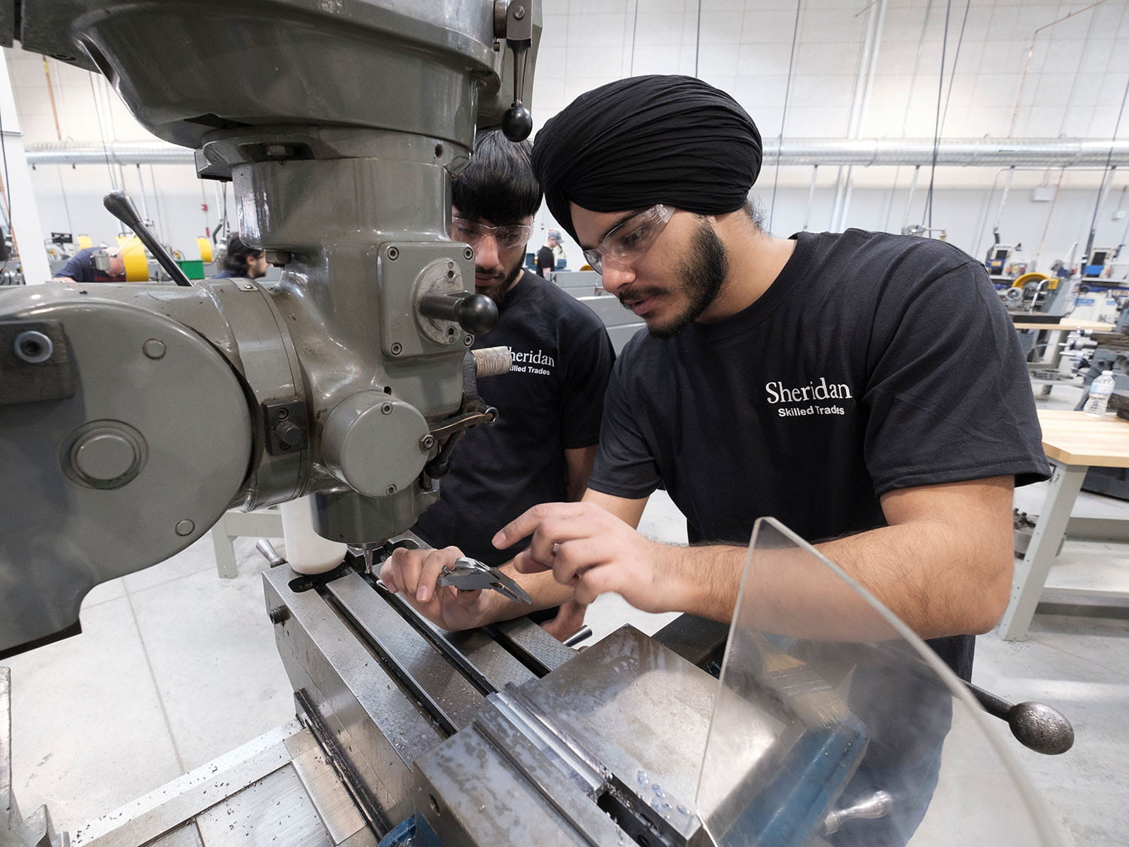 Student working with tools and heavy machinery