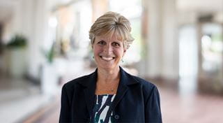Sheridan Provost and Vice-President Academic Mary Vaughan is pictured standing in a foyer with a blurred background