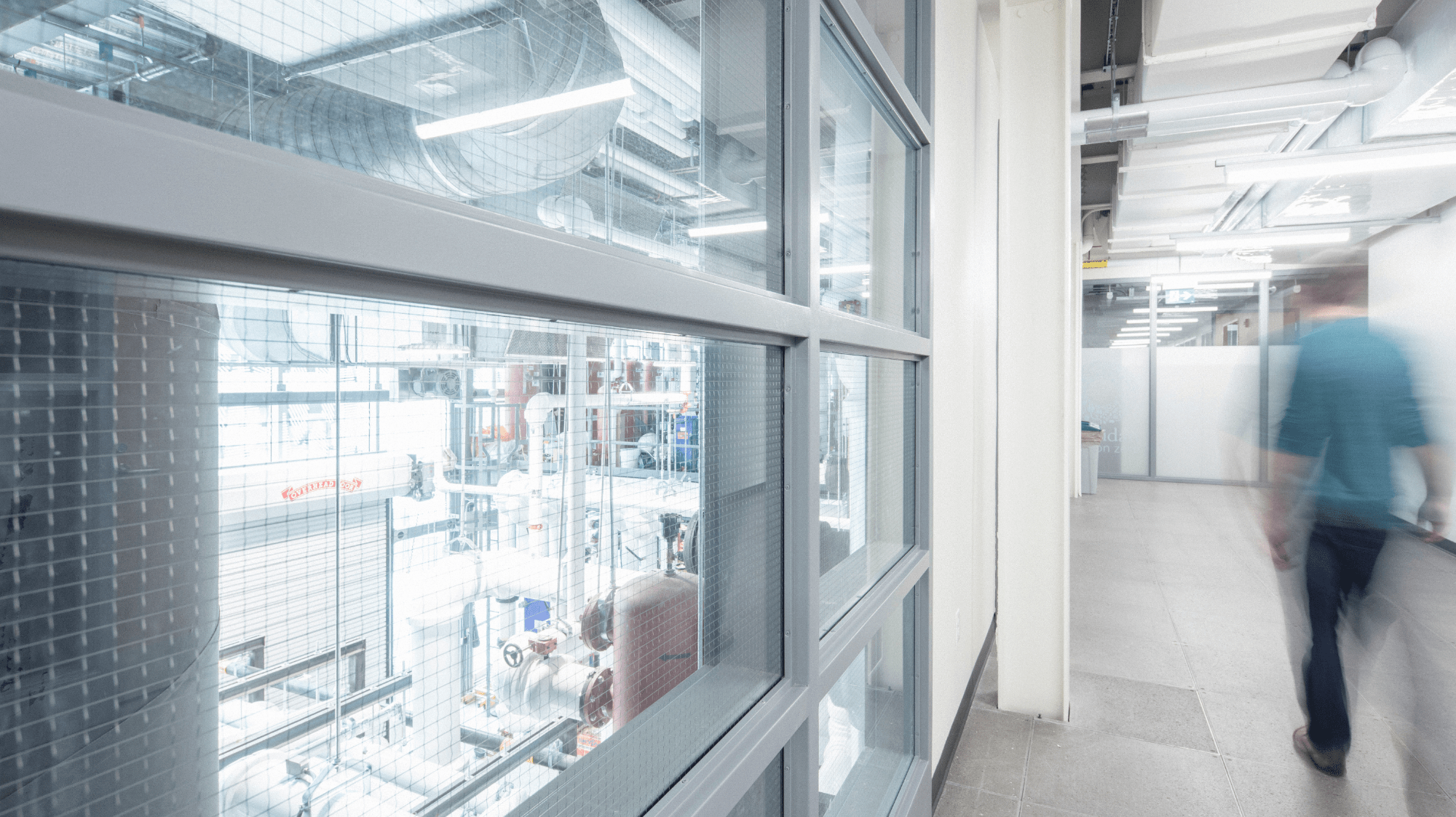 A hallway at Sheridan's Skilled Trades Centre with windows overlooking a workshop below.