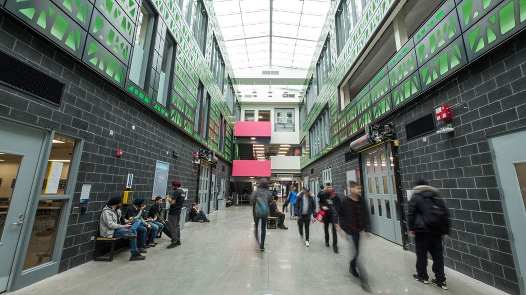 Students walking down the hall in the three-storey atrium at Sheridan's new Skilled Trades Centre.