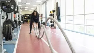 An athlete doing battle rope exercises in Sheridan's Strength and Conditioning Facility
