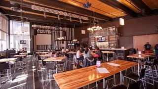 Students eating at tables in Sheridan's pub, The Den