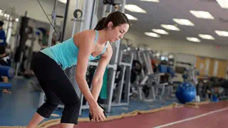 A woman using exercise equipment in the Athletic Complex at Sheridan's Davis Campus.