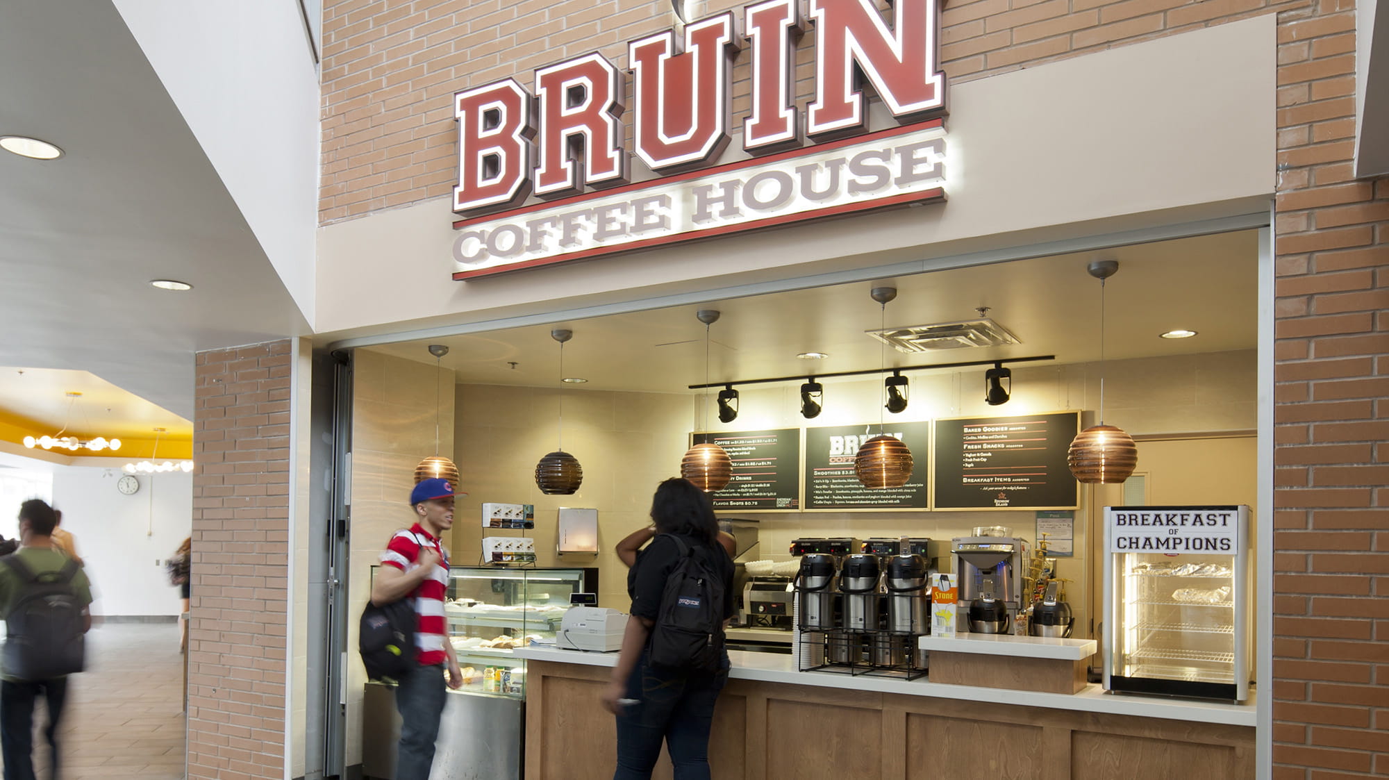 The Bruin Coffee House sign over the counter where students are ordering coffee