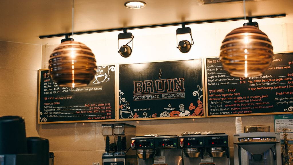 A wall with chalk boards showing the menu for the Bruin Coffee House at Sheridan