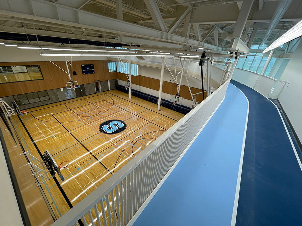 View of the basketball court from standing on the running track above, in the Student Centre at Hazel McCallion Campus.