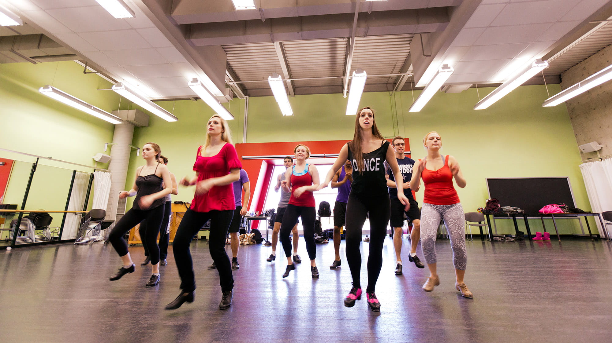 A group of students tap dancing in a dance studio