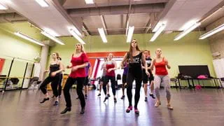 A group of students tap dancing in a dance studio