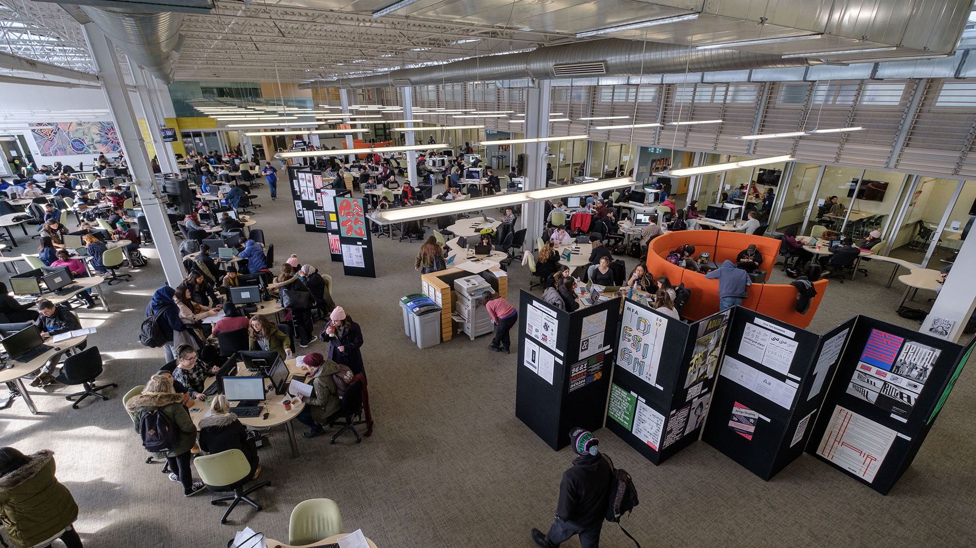 Groups of students working on computers inside the Learning Commons