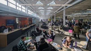 Groups of students working at tables inside the Learning Commons
