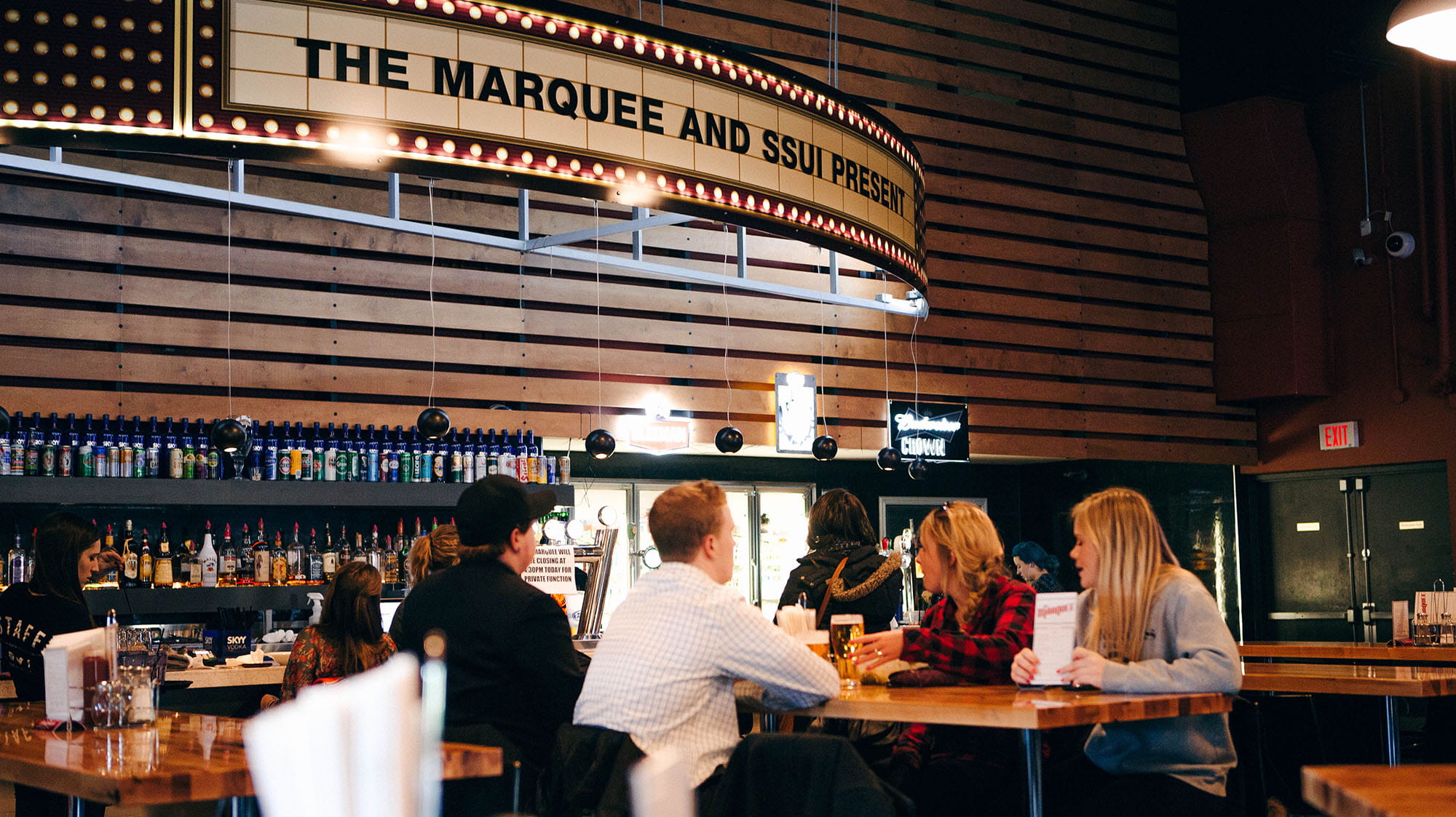 Students eating at a table by the bar in the Marquee