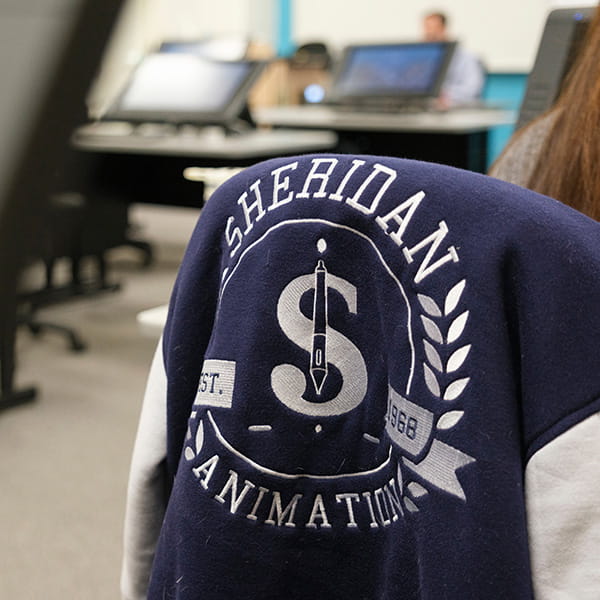 Jacket draped over a chair with 'SHERIDAN ANIMATION' written on the back