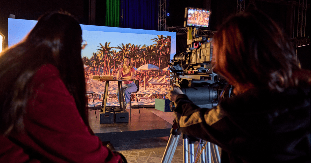 People behind a camera filming someone 