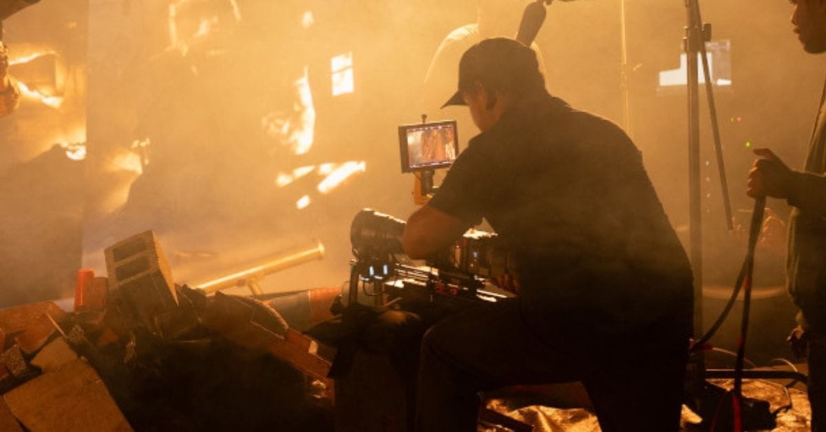 A person working with a film camera