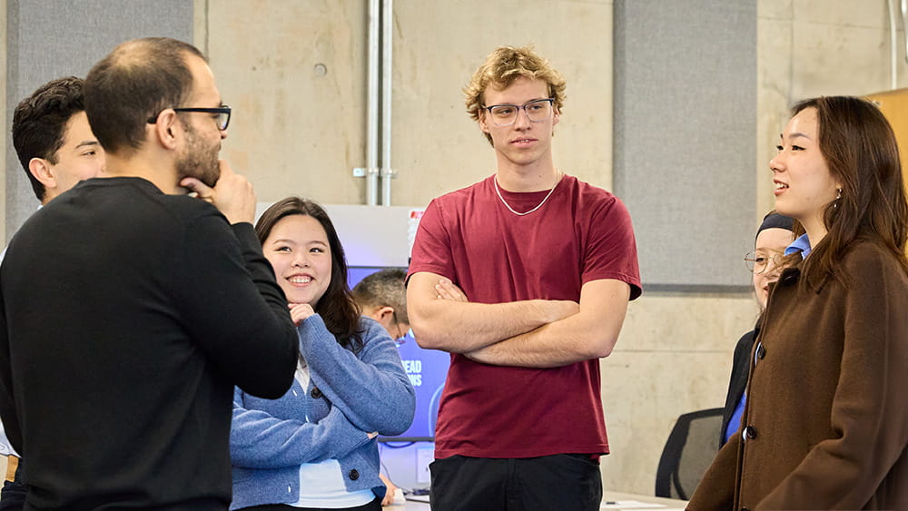 Group standing together engaged in a discussion