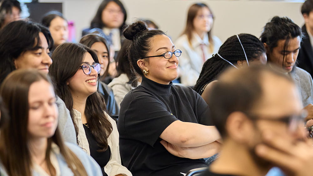 Group of people seated as an audience, looking in the same direction
