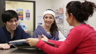 A student and parent reviewing a booklet