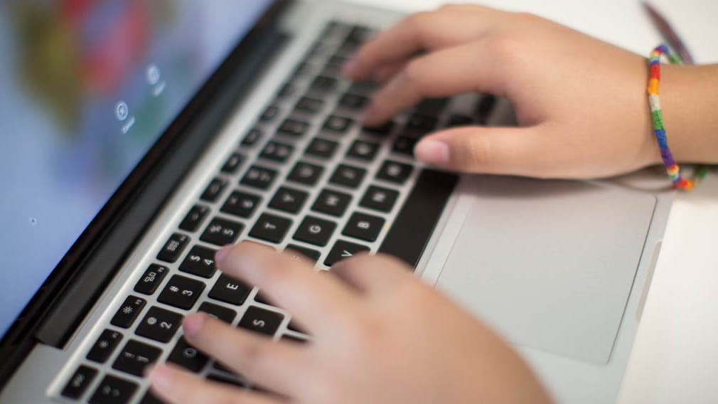 Close-up of hands typing on a keyboard
