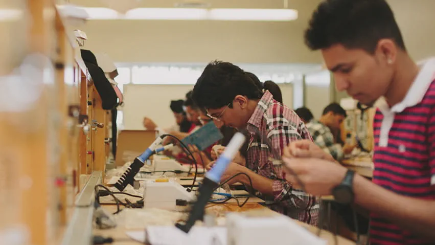 Students working with program equipment