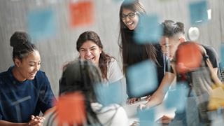 Students smiling and having a discussion.