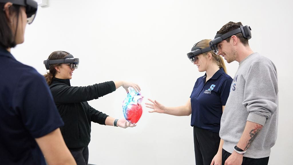 Four healthcare students wearing VR headsets