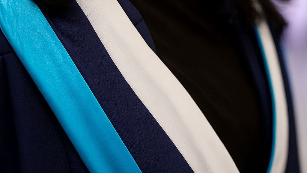 Certificate with sash in Sheridan colours laying on top.