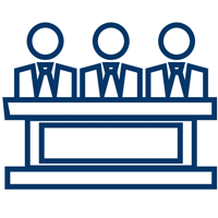 Three figures sitting side-by-side behind a table