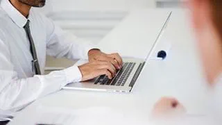 Person typing on a laptop