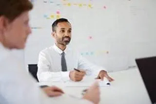 A person sitting at a table and taking notes.