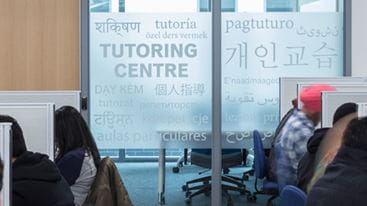 Students seated at study cubicles in front of the Tutoring Centre.