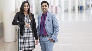 Two Sheridan alumni standing at Toronto Pearson Airport