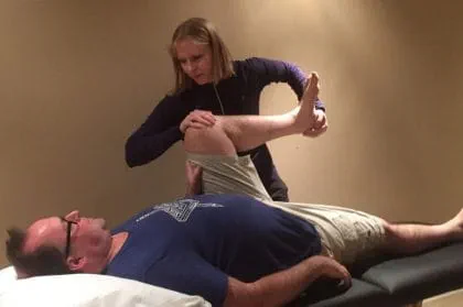 Jennifer Johnson working on a patient at her clinic