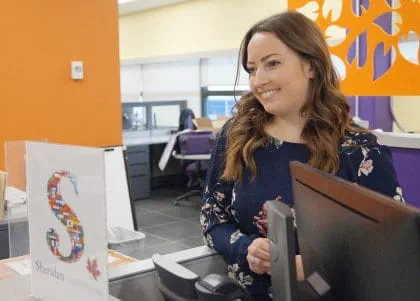 Melanie Jablonski at the International Centre welcome desk at Trafalgar Campus.