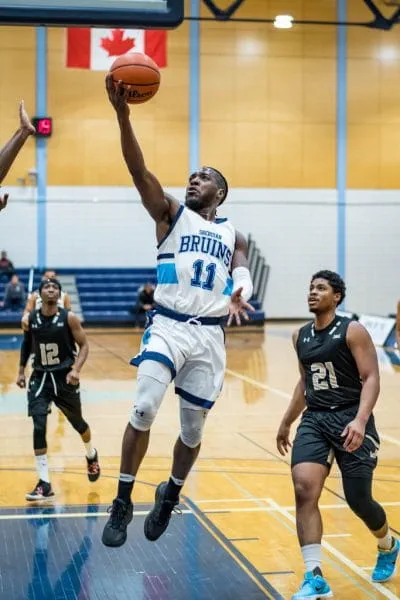 Nick Campbell in the air with the basketball