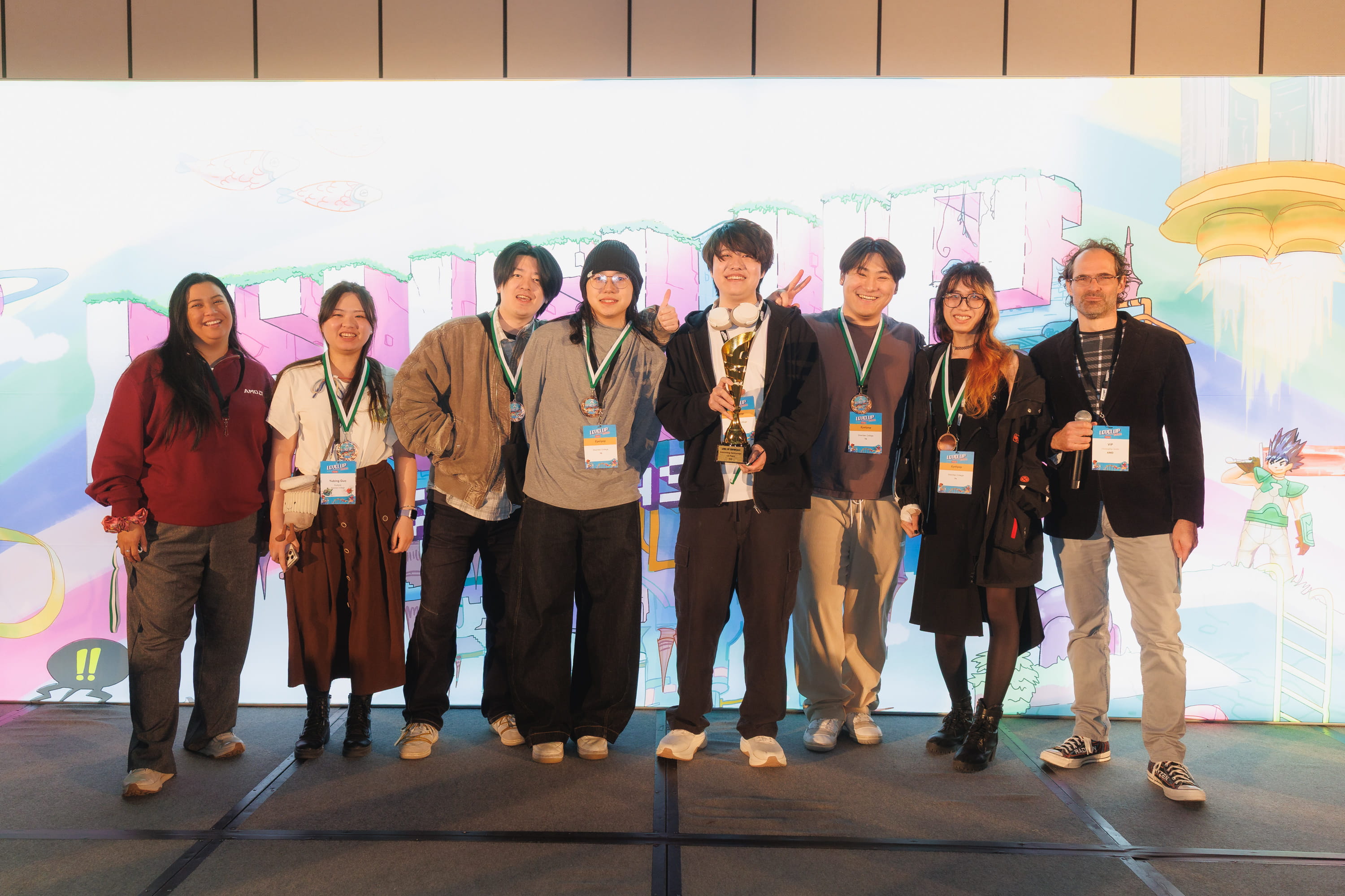The eight-person team that designed Aroma stands on stage after winning an award at Level Up