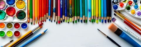 Various art supplies, including pencil crayons, brushes and paint