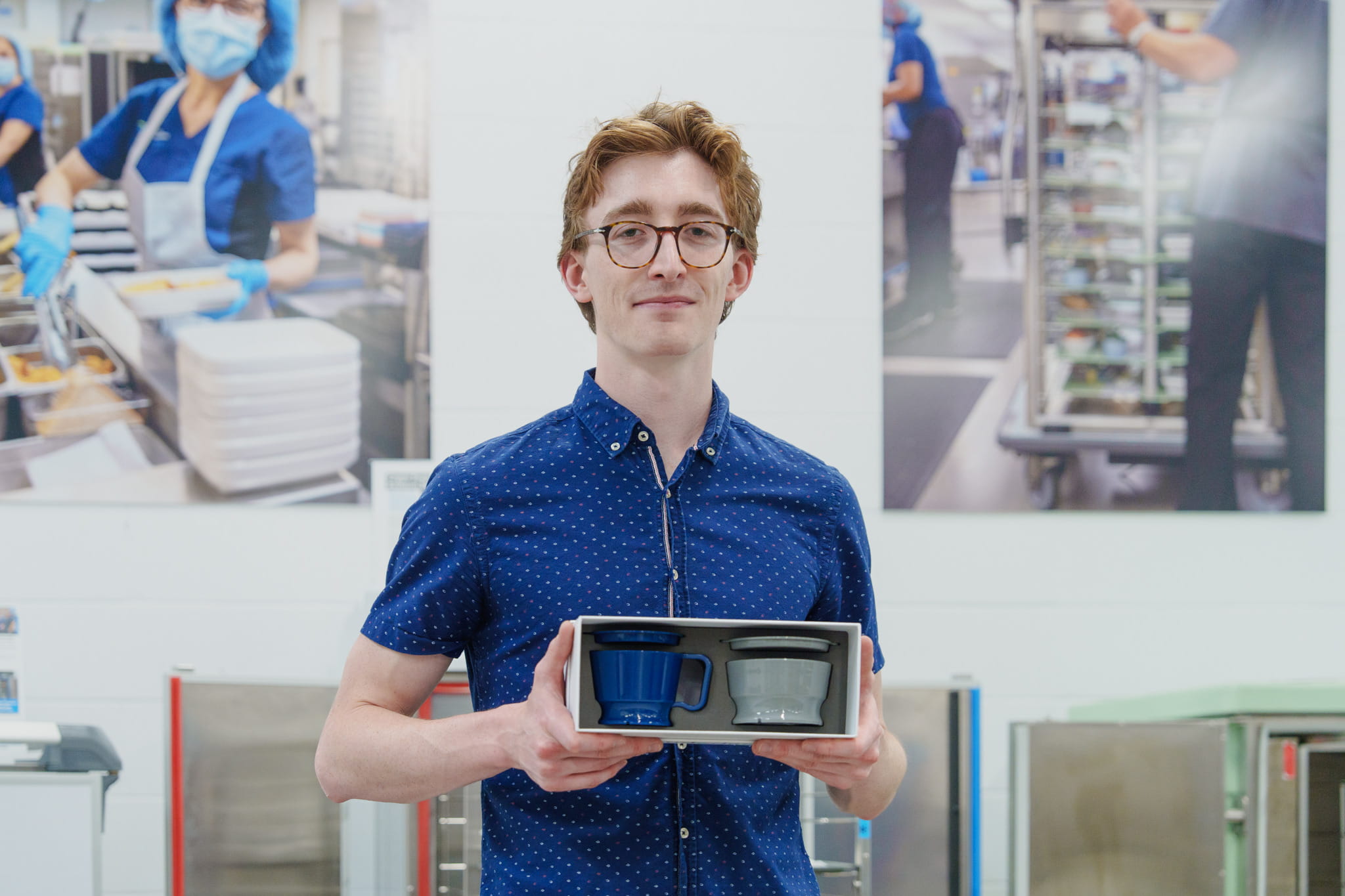 Industrial Design graduate Tobin Nickle-Lott holds samples of the cup and bowl system that he designed as a student
