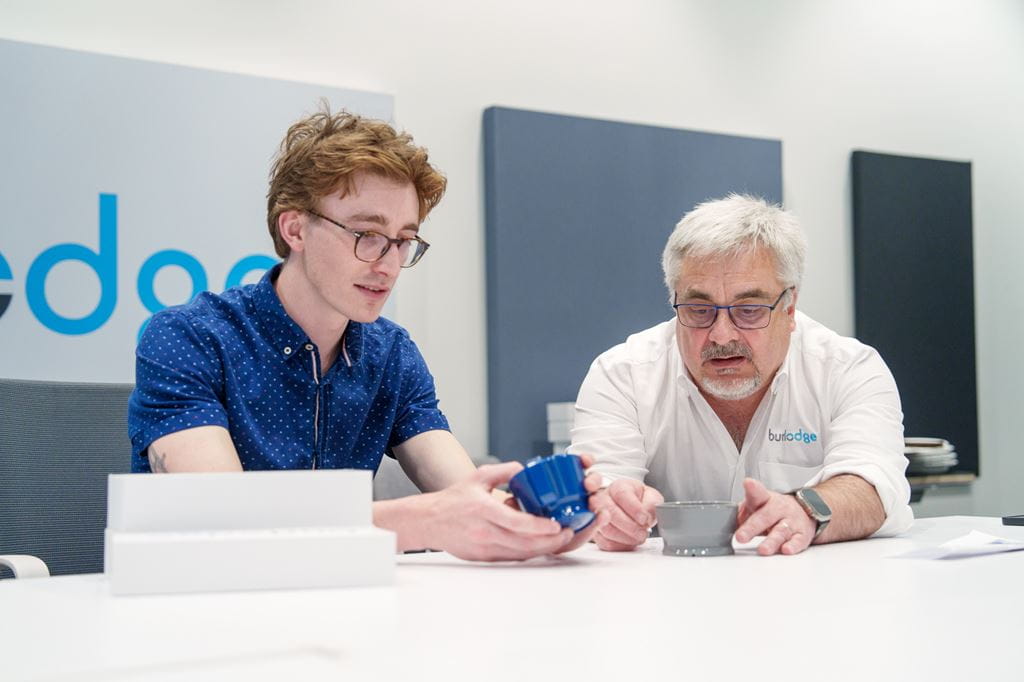 Industrial Design graduate Tobin Nickle-Lott and Burlodge Canada President Paul Gauntley look at the new cup and bowl system together