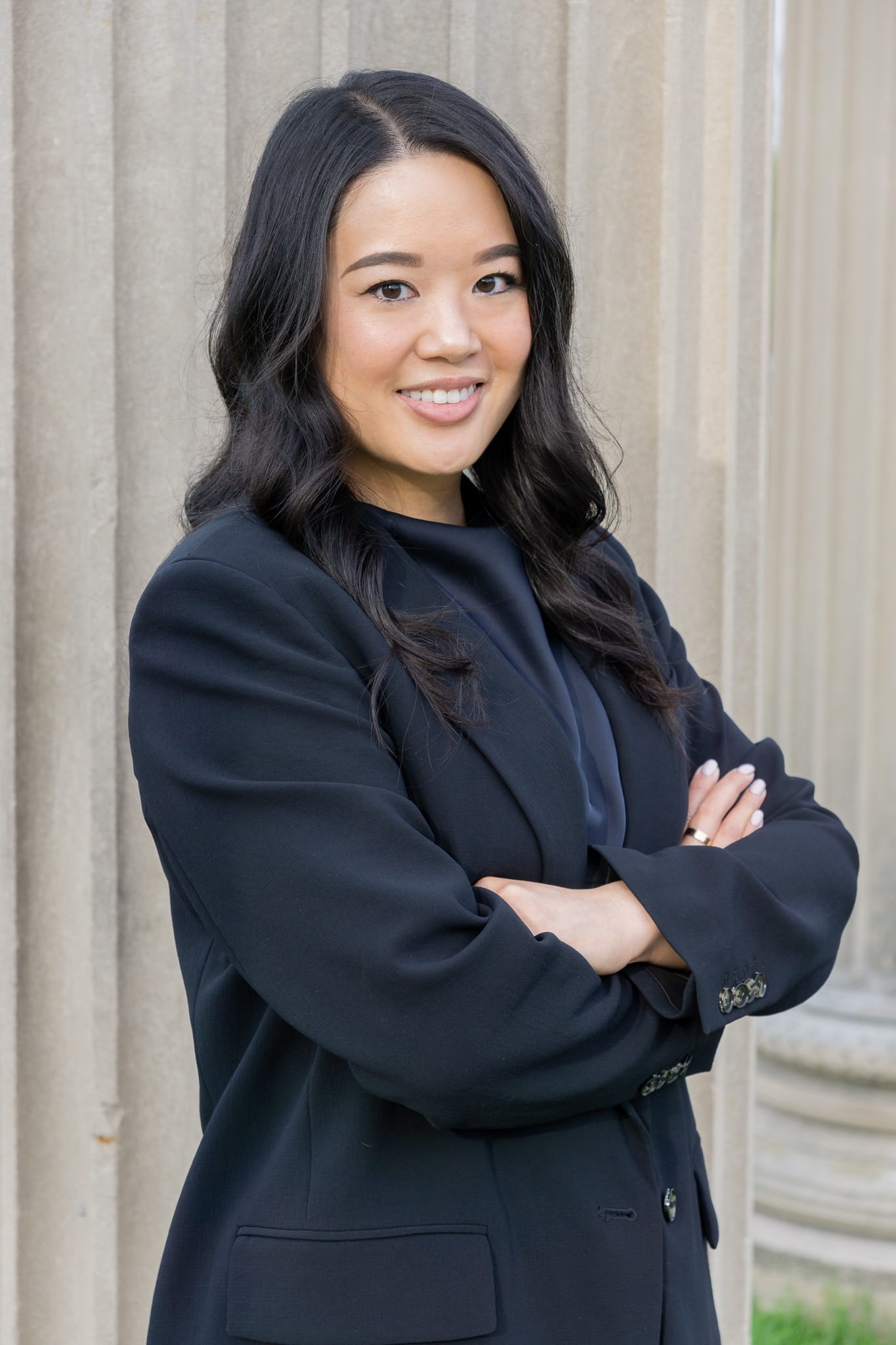 Francesca Mak poses for a photo wearing a blazer and with her arms crossed