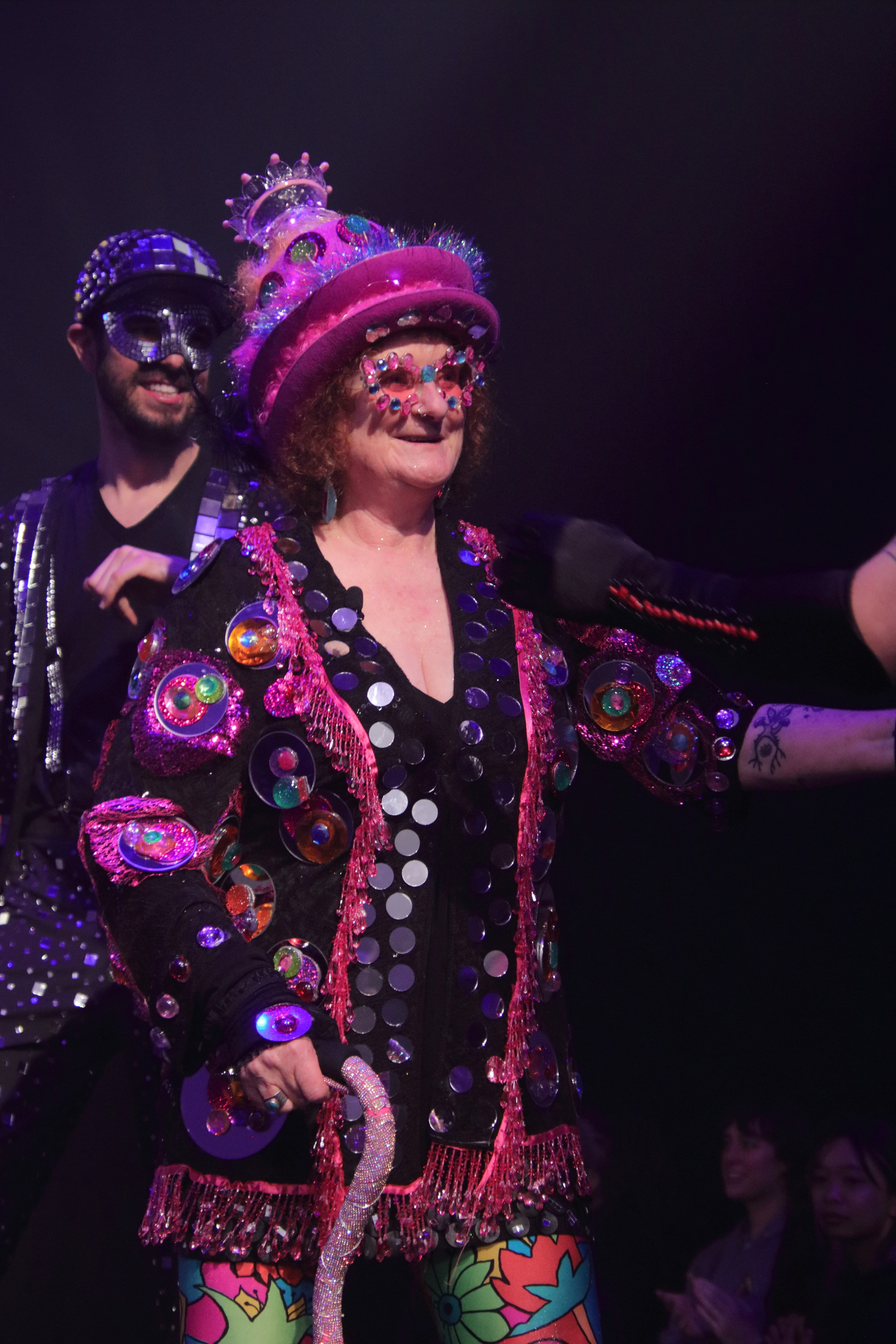 Glass artist and show creator Laura Donefer in her glass outfit on stage.