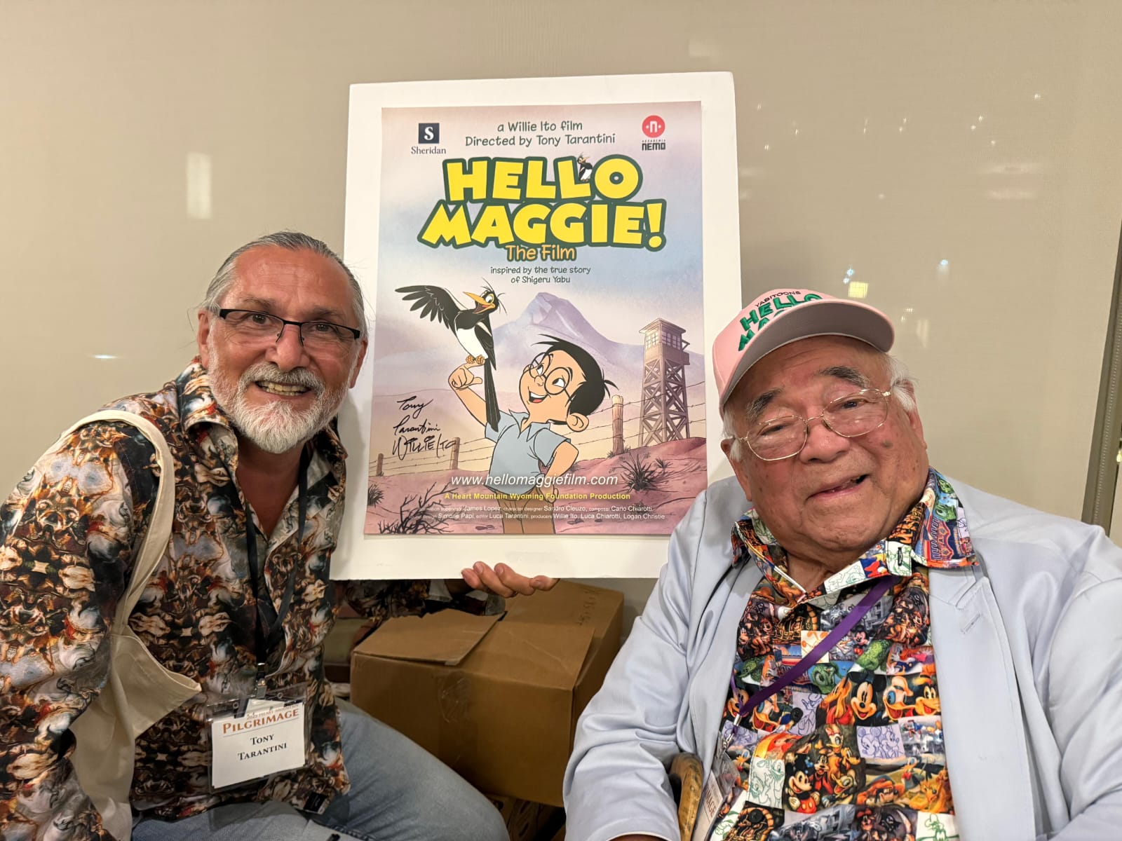 Sheridan animation professor Tony Tarantini and longtime Disney animator Willie Ito pose for a photo in front of a Hello Maggie promotional poster