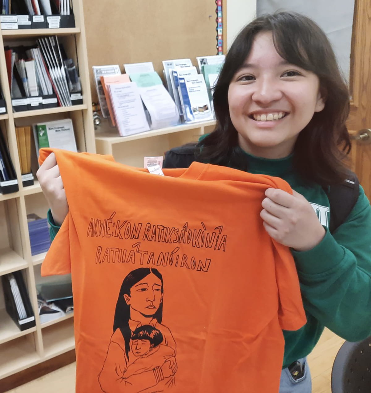 Kanerahtaien Doxtador-Swamp shows the orange shirt design she created as a high school student