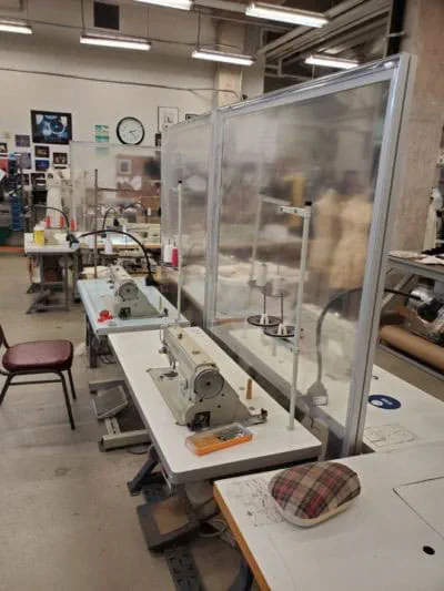 Plexiglass dividers separate workstations to protect students during COVID-19