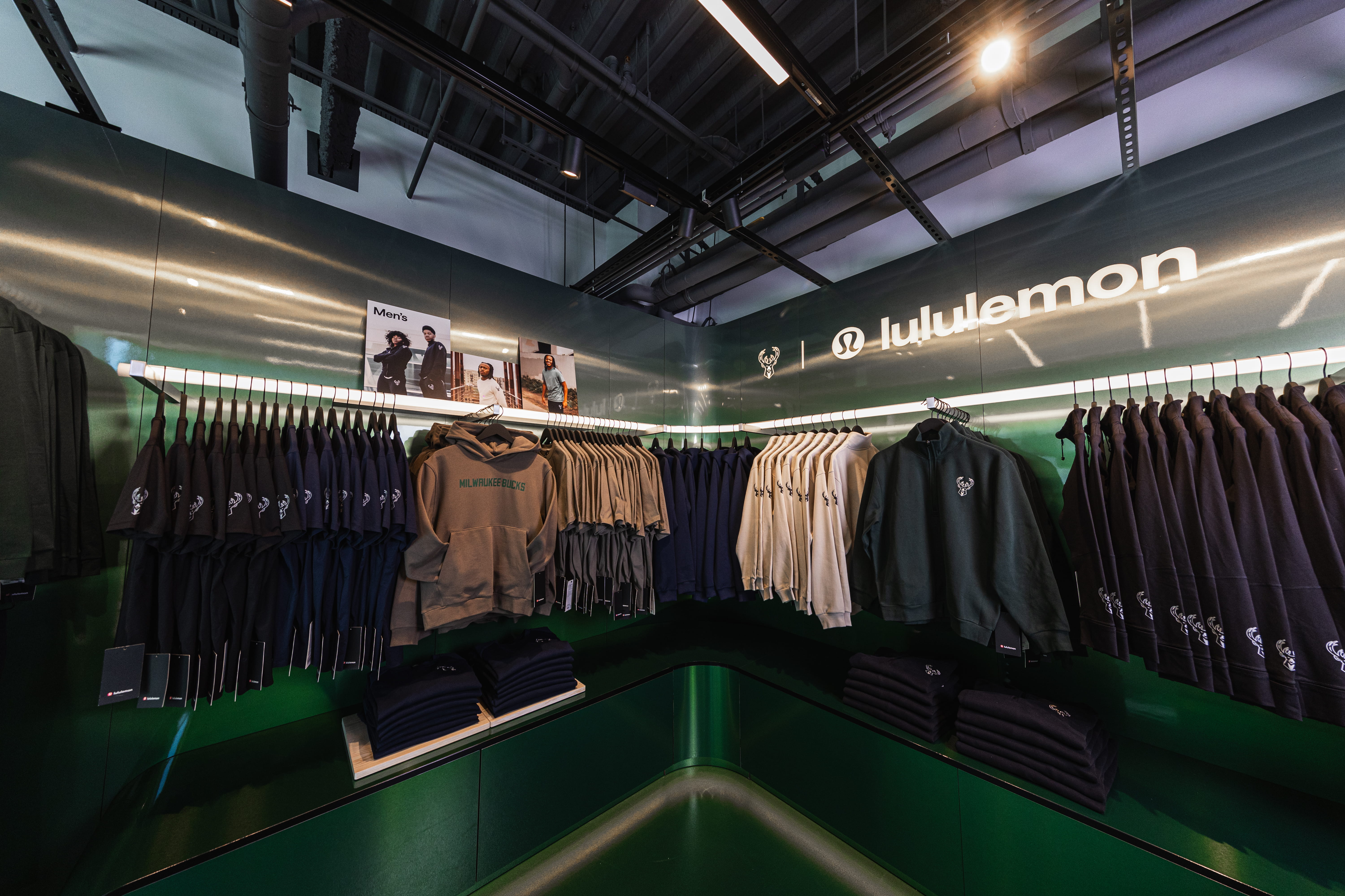 Shirts with Milwaukee Bucks NBA branding hang inside a lululemon pop-up shop inside the Bucks' home arena