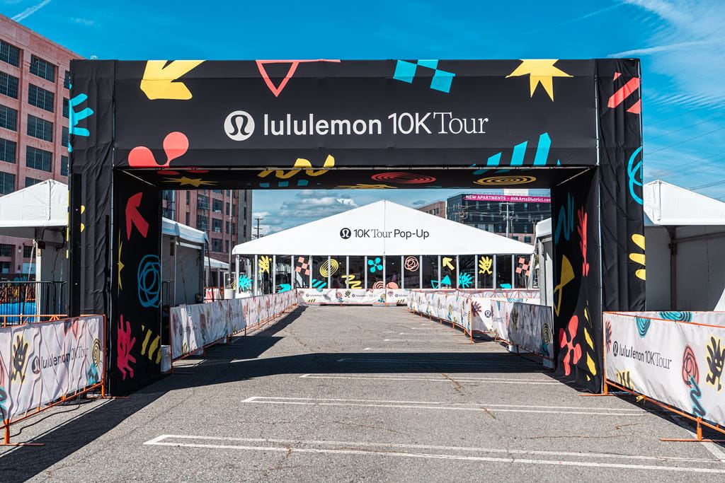 the finish line at the lululemon 10k Tour race, with a 10K Tour lululemon pop-up store in the background