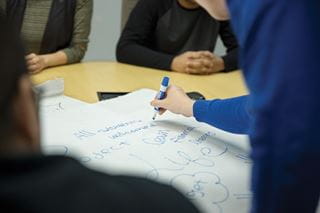 Student writing on paper