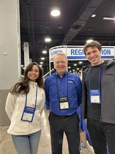 Sheridan business students Hannah Braz and Alan Switas pose for a photo with Fastenal CEO Daniel Florness during a company event in Nashville, Tennessee
