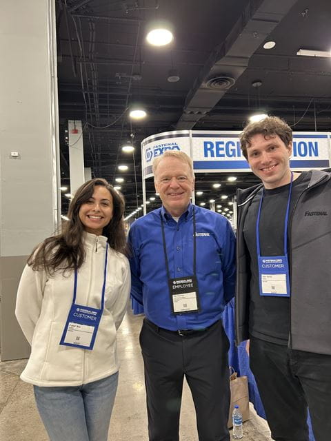 Sheridan business students Hannah Braz and Alan Switas pose for a photo with Fastenal CEO Daniel Florness during a company event in Nashville, Tennessee