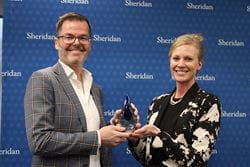 Representative from Figure3 accepting the 2023 Co-op and Internship Employer of the Year Award from Sheridan